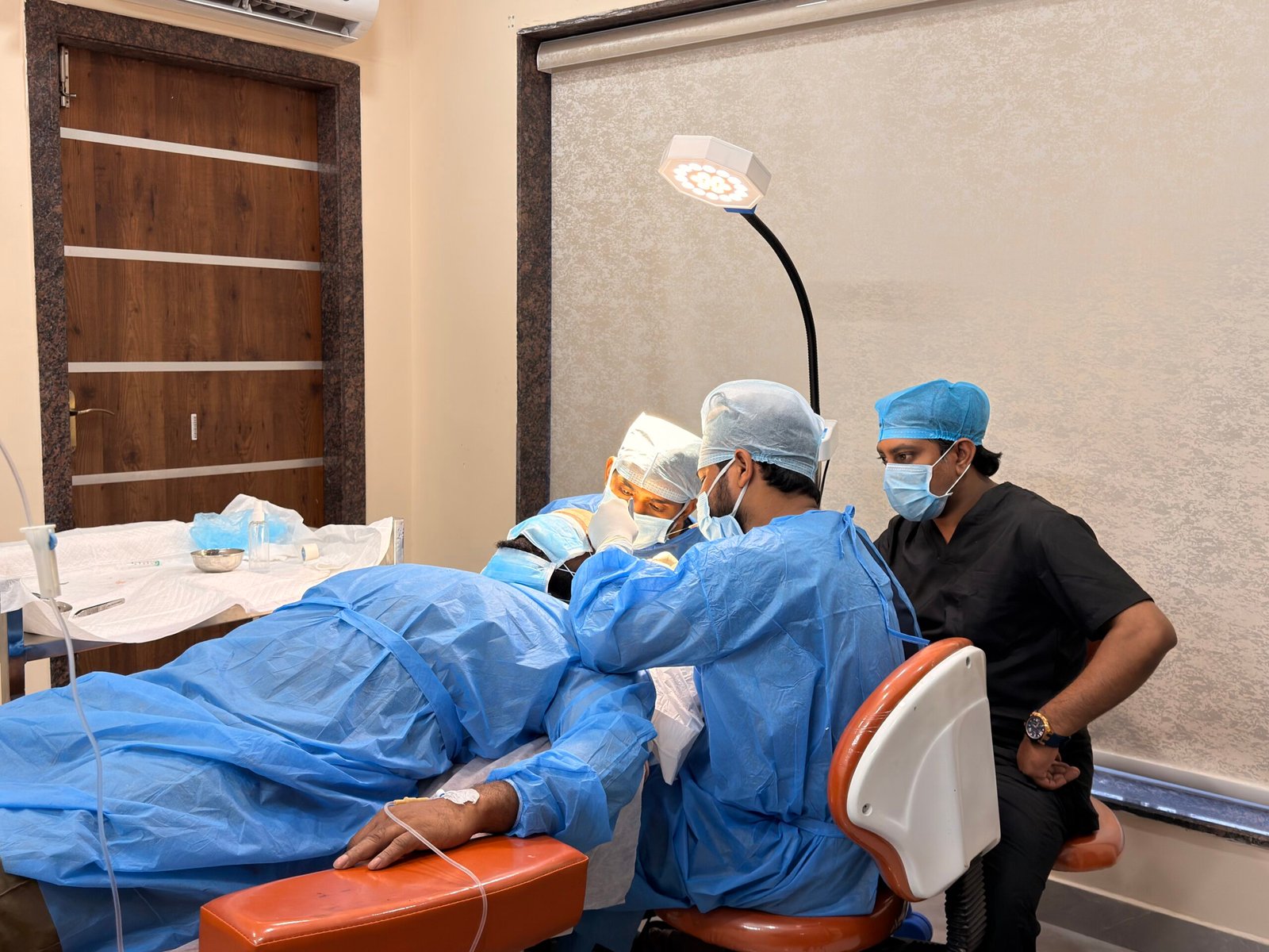 Gowned surgical team performing a hair transplant in the procedure room at Hair Reborn, Asilmetta, Visakhapatnam
